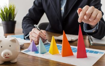 front-view-businessman-with-colorful-cones-representing-growth